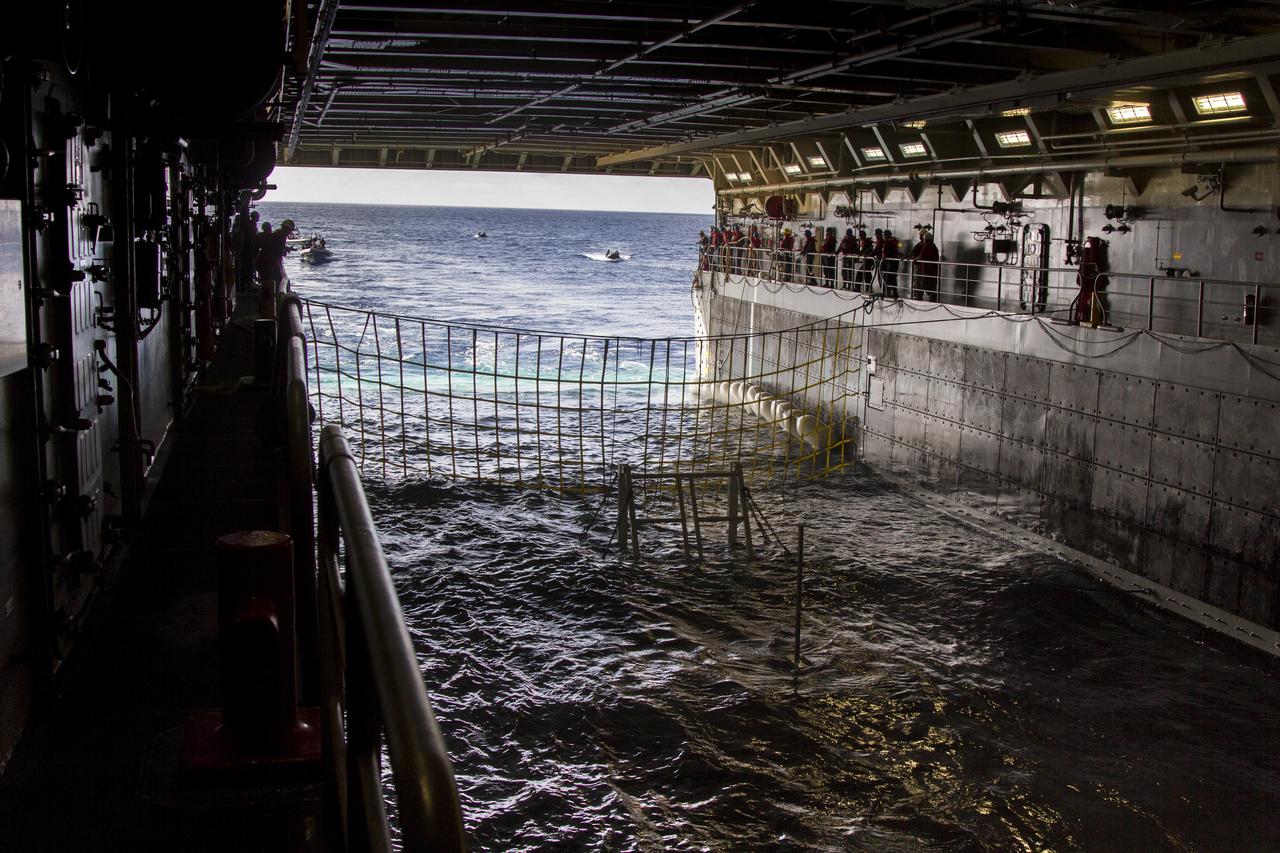 On the third day of preparations for recovery of Orion after its splashdown in the Pacific Ocean, the well deck of the USS Anchorage has been filled with water and recovery hardware is in place. U.S. Navy divers have embarked from ship to practice recovery procedures in rigid hull inflatable boats and Zodiac boats. NASA, Lockheed Martin and U.S. Navy personnel are preparing for recovery of the crew module, forward bay cover and parachutes on its return from space and splashdown in the Pacific Ocean. The Ground Systems Development and Operations Program is leading the recovery efforts. 