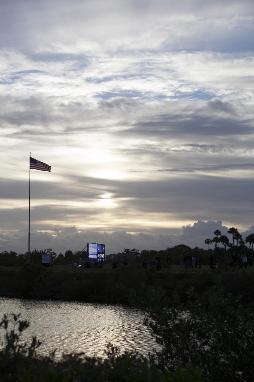 At NASA's Kennedy Space Center in Florida, the new countdown clock at the spaceport's Press Site is used for the first time as preparations were underway for the Orion Flight Test. The modern, multimedia display is similar to the screens seen at sporting venues. The new screen is nearly 26 feet wide by 7 feet high, a foot taller than the original clock. 
