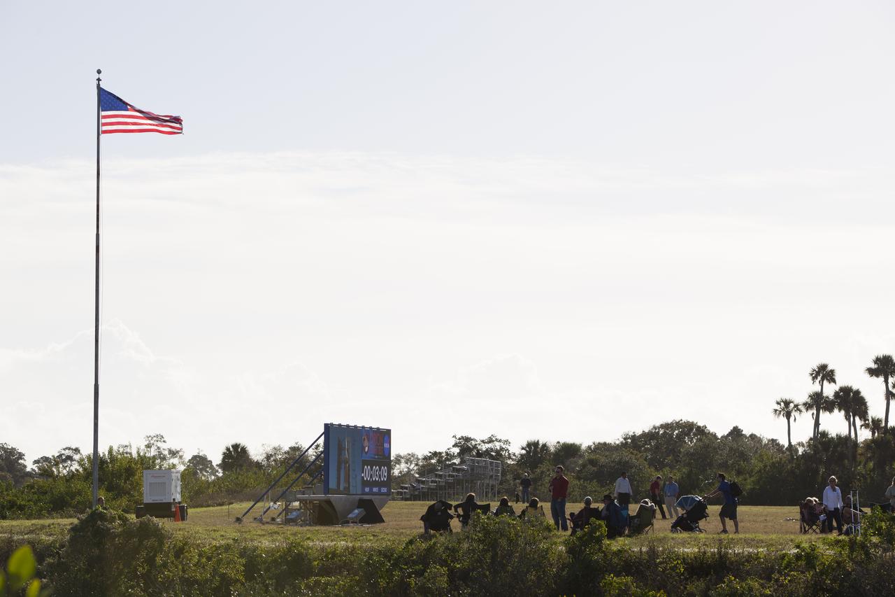 At NASA's Kennedy Space Center in Florida, the new countdown clock at the spaceport's Press Site is used for the first time as preparations were underway for the Orion Flight Test. News media representatives gather in anticipation of the launch of NASA's Orion spacecraft atop a United Launch Alliance Delta IV Heavy rocket.