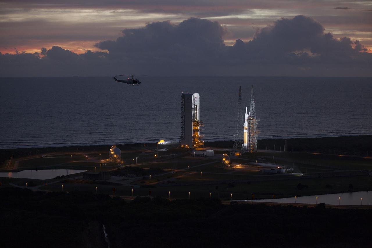 This helicopter view of Space Launch Complex 37 at Cape Canaveral Air Force Station in Florida shows the United Launch Alliance Delta IV Heavy rocket as it stands ready to boost NASA's Orion spacecraft on a 4.5-hour mission. The liftoff was postponed because of an issue related to fill and drain valves on the Delta IV Heavy rocket that teams could not troubleshoot by the time the launch window expired.