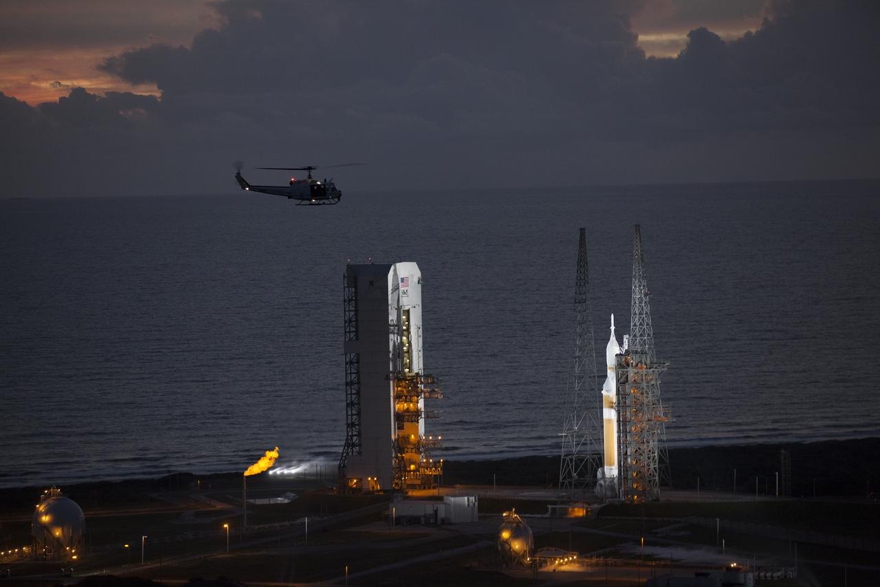 This helicopter view of Space Launch Complex 37 at Cape Canaveral Air Force Station in Florida shows the United Launch Alliance Delta IV Heavy rocket as it stands ready to boost NASA's Orion spacecraft on a 4.5-hour mission. The liftoff was postponed because of an issue related to fill and drain valves on the Delta IV Heavy rocket that teams could not troubleshoot by the time the launch window expired.