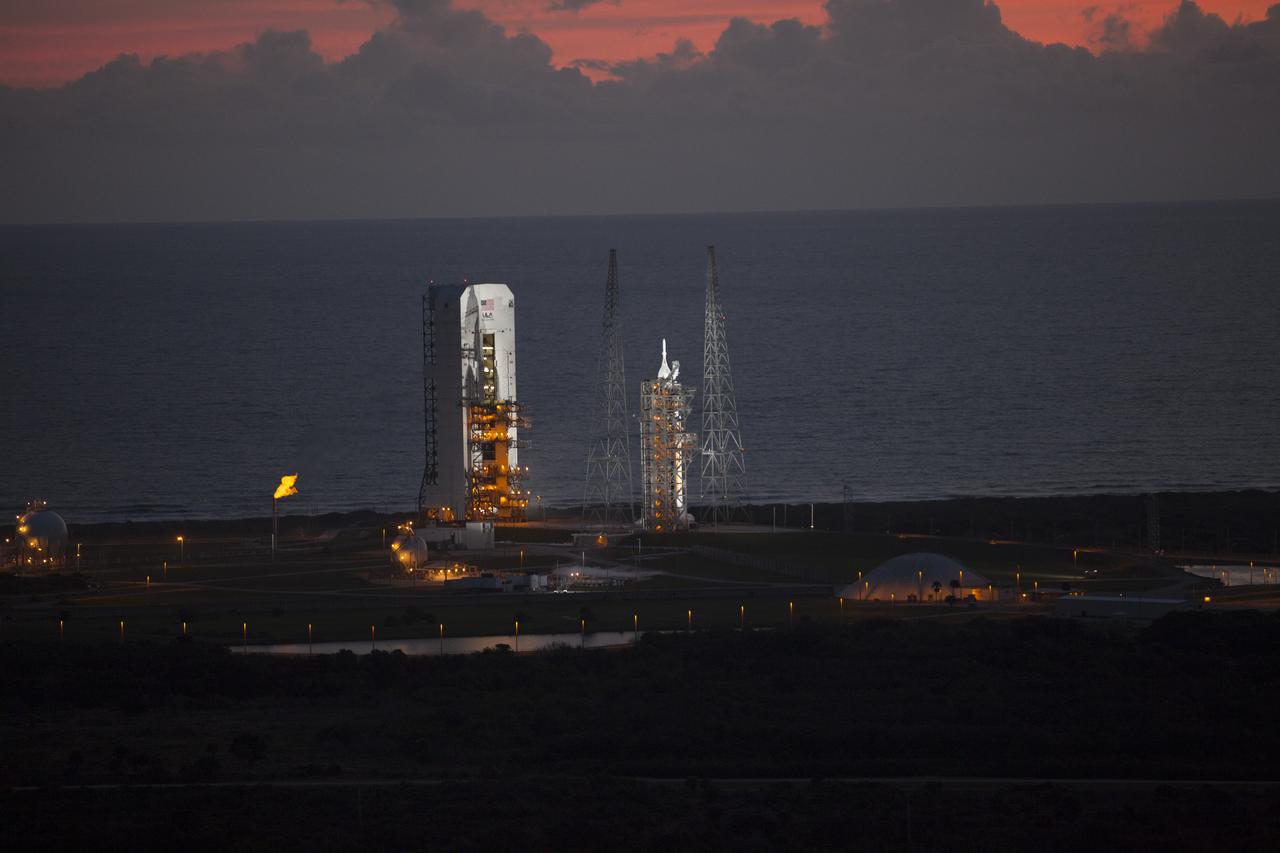 This helicopter view of Space Launch Complex 37 at Cape Canaveral Air Force Station in Florida shows the United Launch Alliance Delta IV Heavy rocket as it stands ready to boost NASA's Orion spacecraft on a 4.5-hour mission. The liftoff was postponed because of an issue related to fill and drain valves on the Delta IV Heavy rocket that teams could not troubleshoot by the time the launch window expired.
