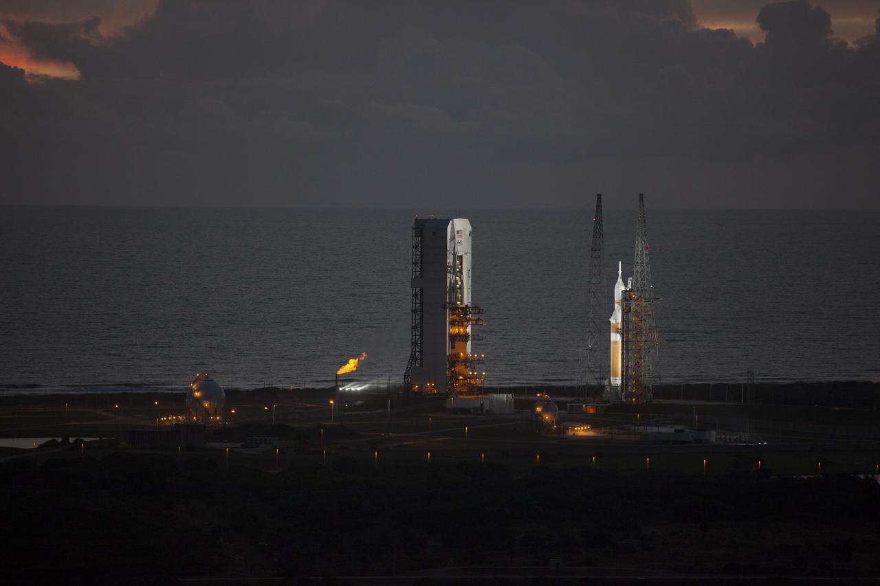 This helicopter view of Space Launch Complex 37 at Cape Canaveral Air Force Station in Florida shows the United Launch Alliance Delta IV Heavy rocket as it stands ready to boost NASA's Orion spacecraft on a 4.5-hour mission. The liftoff was postponed because of an issue related to fill and drain valves on the Delta IV Heavy rocket that teams could not troubleshoot by the time the launch window expired.