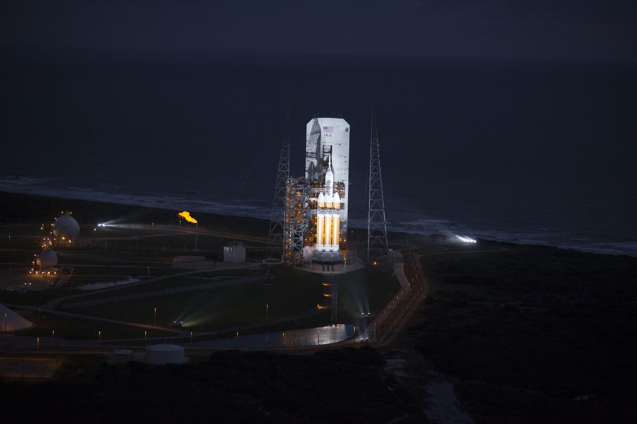 This helicopter view of Space Launch Complex 37 at Cape Canaveral Air Force Station in Florida shows the United Launch Alliance Delta IV Heavy rocket as it stands ready to boost NASA's Orion spacecraft on a 4.5-hour mission.