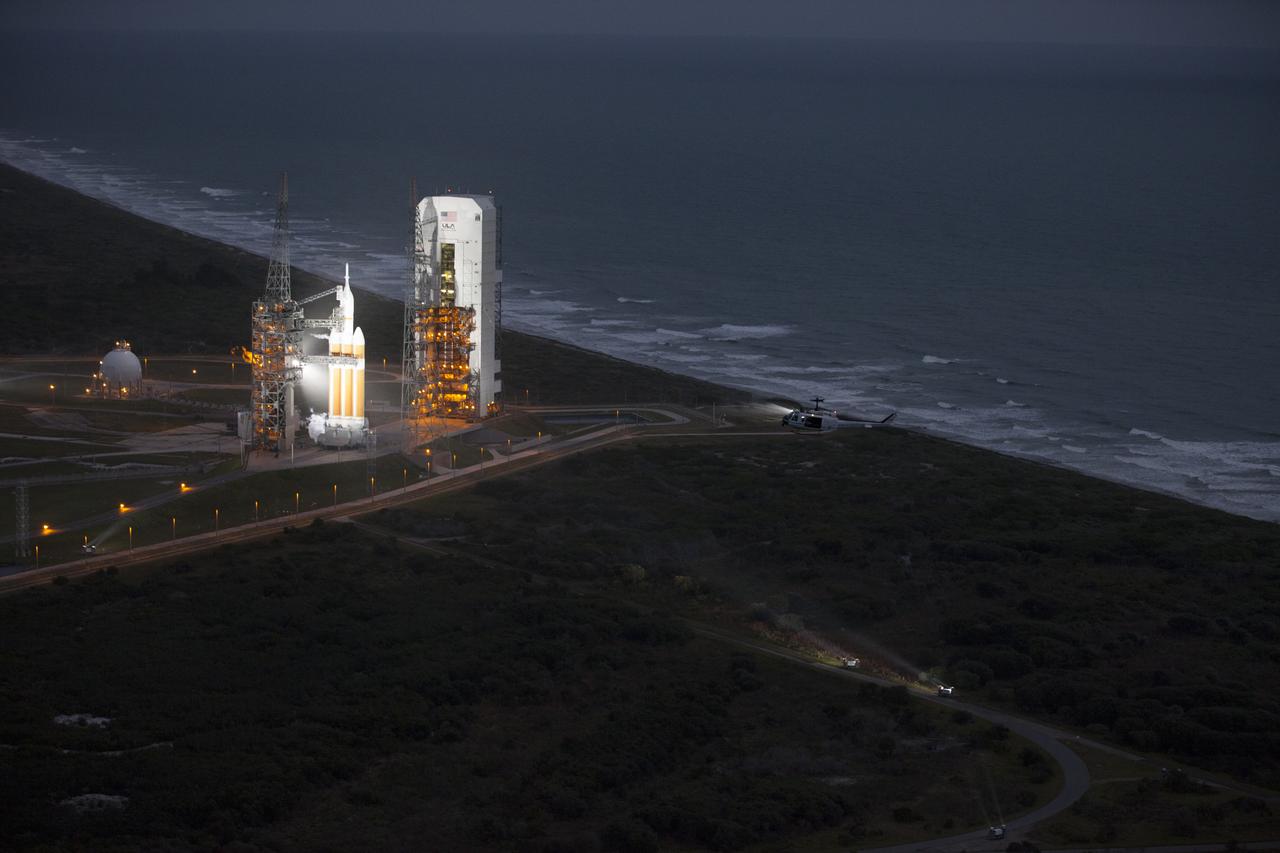 This helicopter view of Space Launch Complex 37 at Cape Canaveral Air Force Station in Florida shows the United Launch Alliance Delta IV Heavy rocket as it stands ready to boost NASA's Orion spacecraft on a 4.5-hour mission.