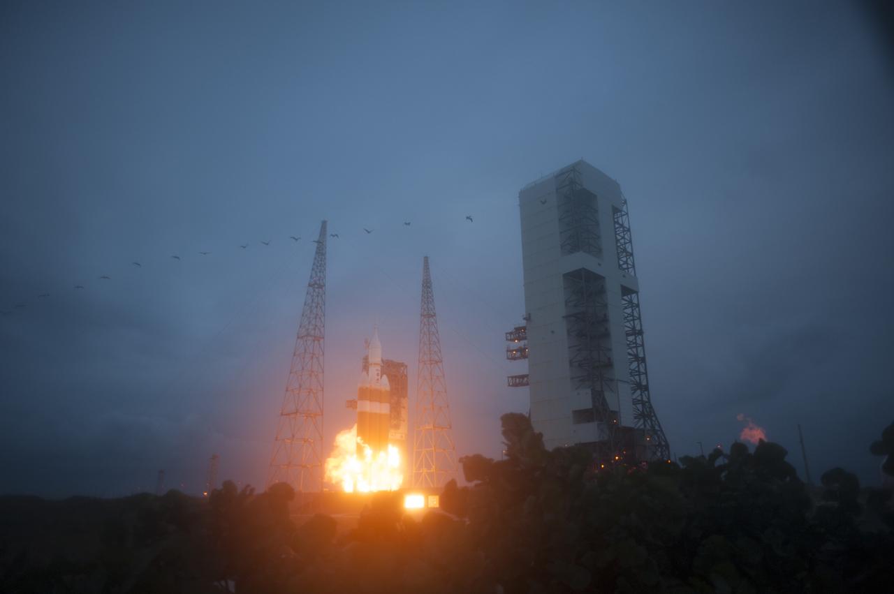 A Delta IV Heavy rocket roars to life at Space Launch Complex 37 at Cape Canaveral Air Force Station in Florida. The launch vehicle is carrying NASA's Orion spacecraft on an unpiloted flight test to Earth orbit. Liftoff was at 7:05 a.m. EST. The flight will send Orion 3,600 miles in altitude beyond the Earth's surface on a four-and-a-half hour mission.