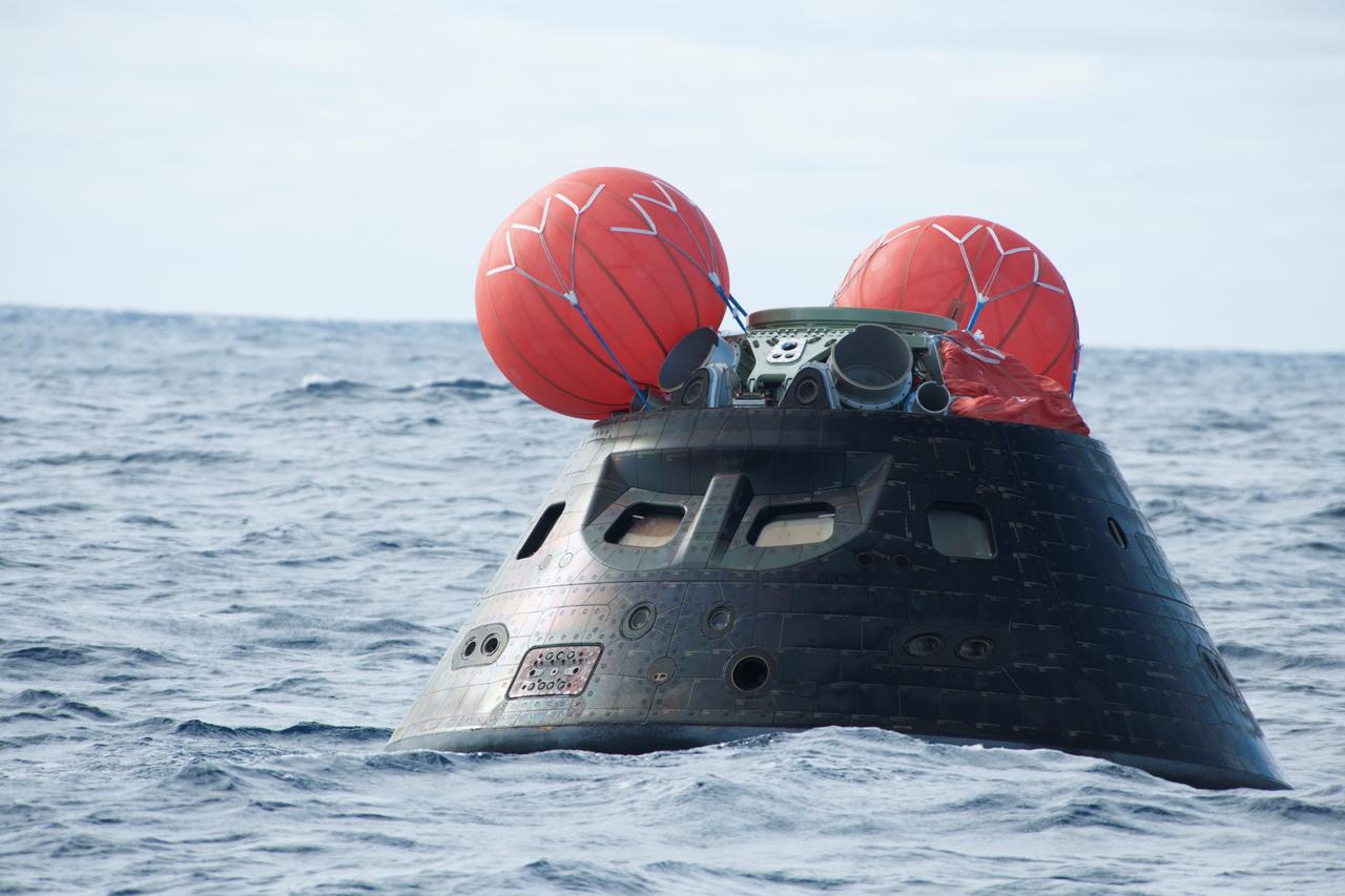 NASA's Orion spacecraft floats in the Pacific Ocean after splashdown from its first flight test in Earth orbit. The spacecraft completed a two-orbit, four-and-a-half-hour mission in Earth orbit. NASA, the U.S. Navy and Lockheed Martin are coordinating efforts to recover Orion, the forward bay cover and main parachutes. Orion will be towed in and secure in the well deck of the nearby USS Anchorage. Orion's mission tested systems critical to crew safety, including the launch abort system, the heat shield and the parachute system. The Ground Systems Development and Operations Program is leading the recovery efforts.