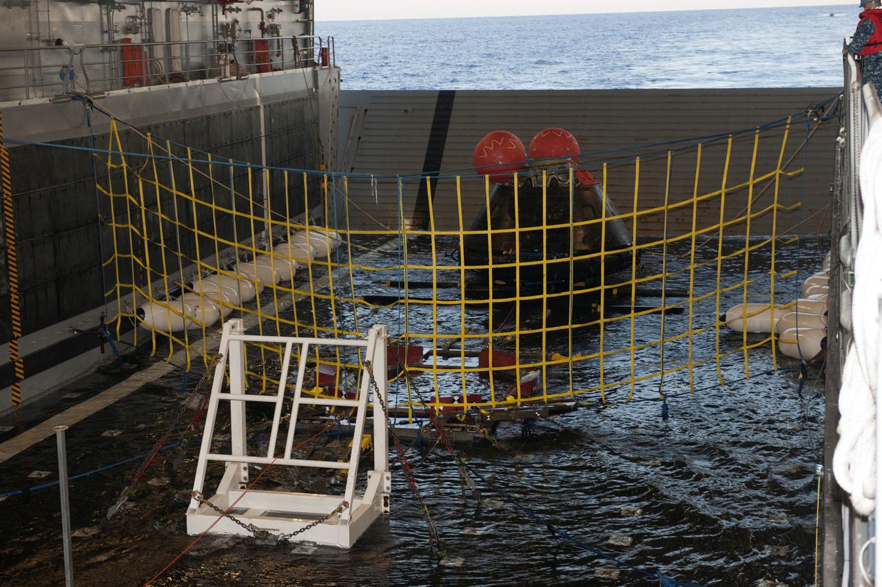 NASA's Orion spacecraft is on rubber bumpers in the flooded well deck of the USS Anchorage in the Pacific Ocean about 600 miles off the coast of San Diego, California. Orion splashed down after its first flight test in Earth orbit. NASA, the U.S. Navy and Lockheed Martin are coordinating efforts to recover Orion and secure the spacecraft in the well deck of the USS Anchorage. Orion completed a two-orbit, four-and-a-half hour mission, to test systems critical to crew safety, including the launch abort system, the heat shield and the parachute system. The Ground Systems Development and Operations Program is leading the recovery efforts. 