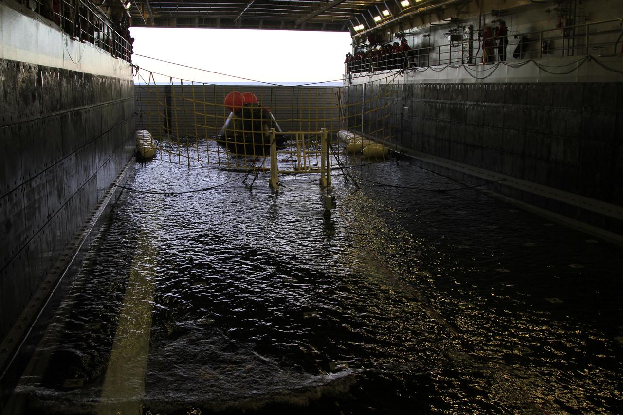 After splashdown, NASA's Orion spacecraft has been recovered and is positioned on rubber "speed bumps" inside the flooded well deck of the USS Anchorage in the Pacific Ocean about 600 miles off the coast of San Diego, California. After lifting off at 7:05 a.m. EST atop a Delta IV Heavy rocket from Space Launch Complex 37 at Cape Canaveral Air Force Station in Florida, Orion completed a two-orbit, four-and-a-half hour mission to test systems critical to crew safety, including the launch abort system, the heat shield and the parachute system. NASA, the U.S. Navy and Lockheed Martin coordinated efforts to recover Orion after splashdown. The Ground Systems Development and Operations Program is leading the recovery efforts. 