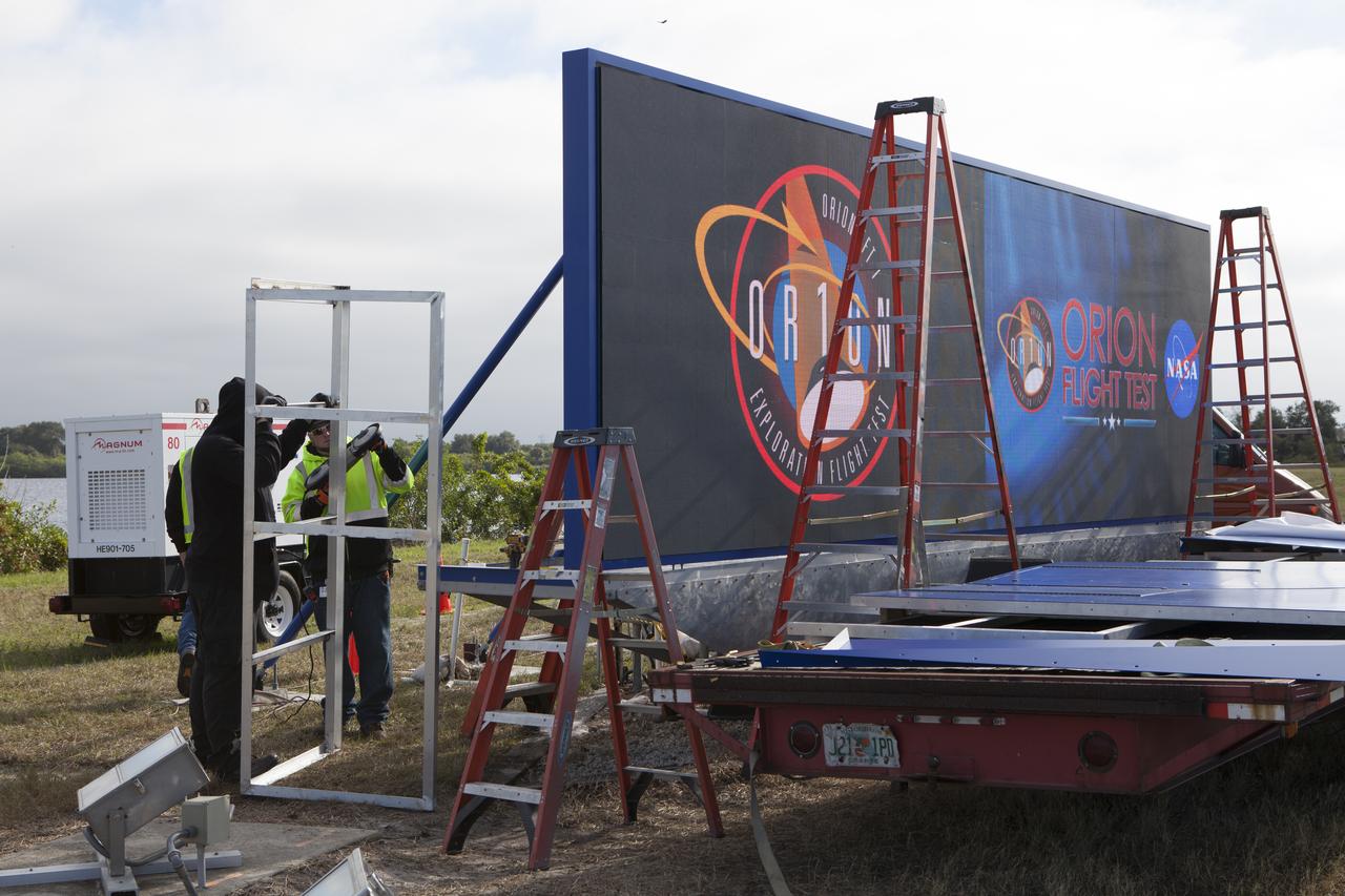 At NASA's Kennedy Space Center in Florida, a shade is placed around the new countdown clock at the spaceport's Press Site. The modern, multimedia display is similar to the screens seen at sporting venues. The new screen is nearly 26 feet wide by 7 feet high, a foot taller than the original clock. The historic countdown clock was designed by Kennedy engineers and built by space center technicians before Apollo 12 in 1969. NASA has acquired the countdown clock from the agency’s Artifact Working Group at the agency's Headquarters for display at the Kennedy Space Center Visitor Complex.