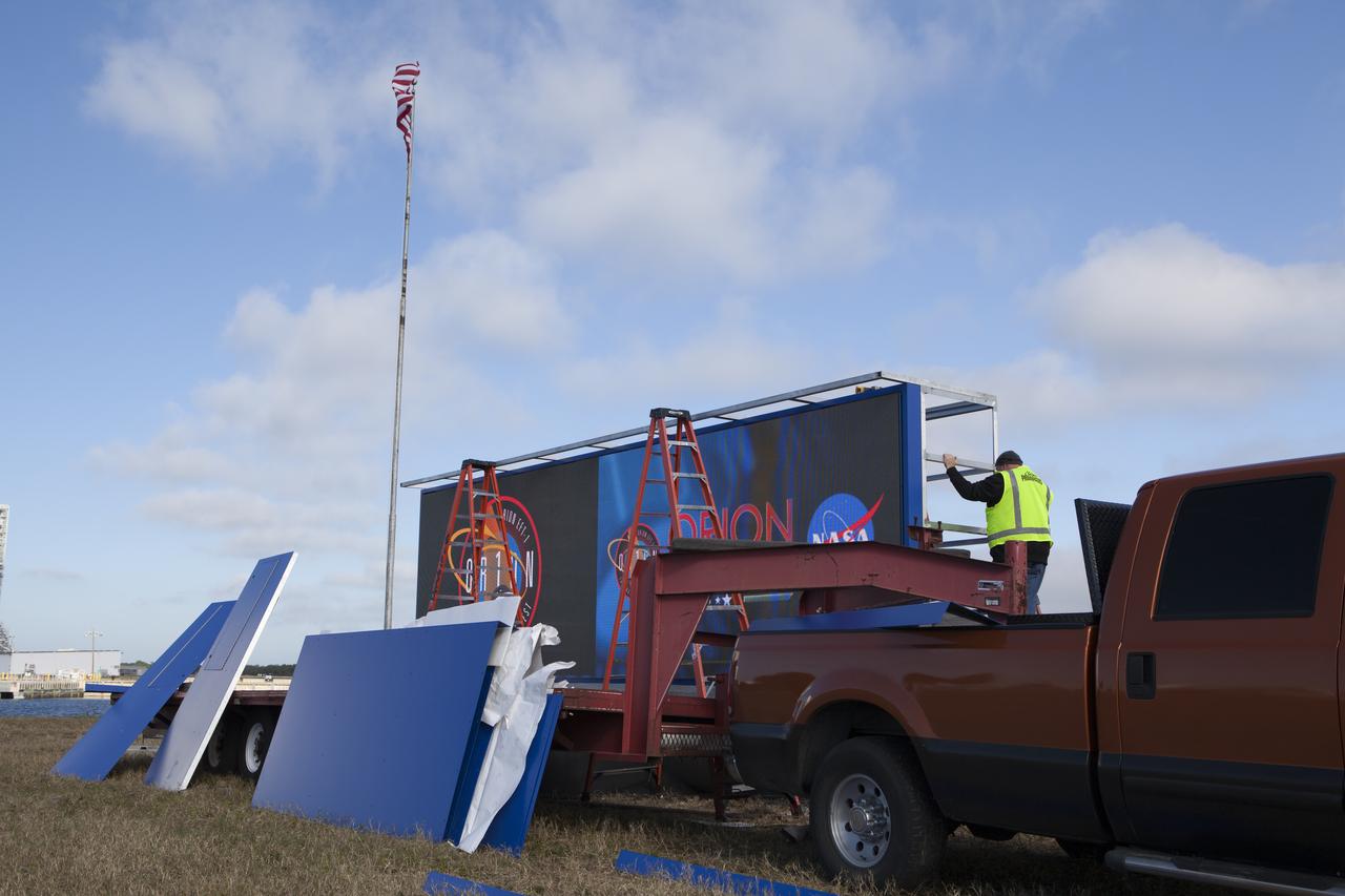 At NASA's Kennedy Space Center in Florida, a shade is placed around the new countdown clock at the spaceport's Press Site. The modern, multimedia display is similar to the screens seen at sporting venues. The new screen is nearly 26 feet wide by 7 feet high, a foot taller than the original clock. The historic countdown clock was designed by Kennedy engineers and built by space center technicians before Apollo 12 in 1969. NASA has acquired the countdown clock from the agency’s Artifact Working Group at the agency's Headquarters for display at the Kennedy Space Center Visitor Complex. 