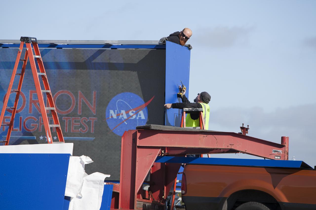 At NASA's Kennedy Space Center in Florida, a shade is placed around the new countdown clock at the spaceport's Press Site. The modern, multimedia display is similar to the screens seen at sporting venues. The new screen is nearly 26 feet wide by 7 feet high, a foot taller than the original clock. The historic countdown clock was designed by Kennedy engineers and built by space center technicians before Apollo 12 in 1969. NASA has acquired the countdown clock from the agency’s Artifact Working Group at the agency's Headquarters for display at the Kennedy Space Center Visitor Complex. 
