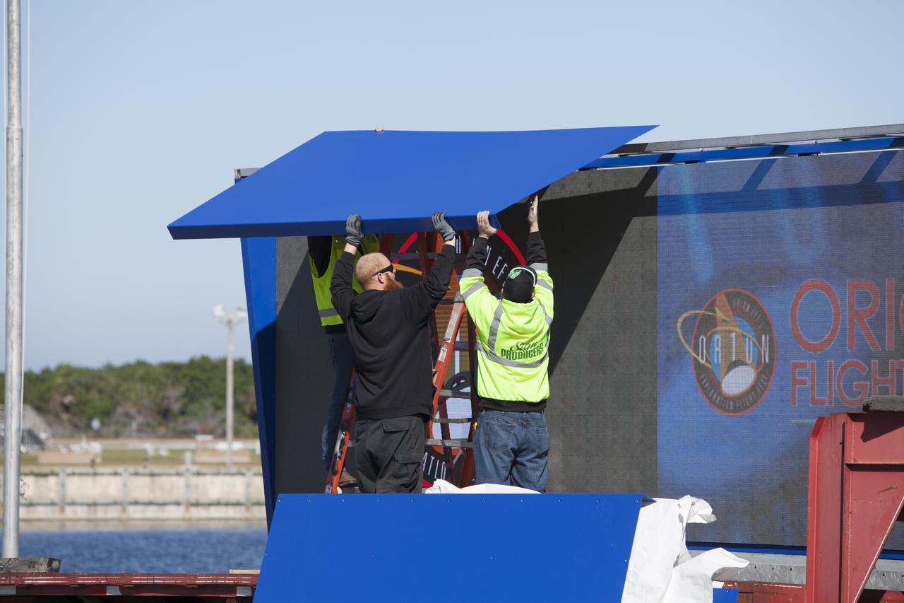 At NASA's Kennedy Space Center in Florida, a shade is placed around the new countdown clock at the spaceport's Press Site. The modern, multimedia display is similar to the screens seen at sporting venues. The new screen is nearly 26 feet wide by 7 feet high, a foot taller than the original clock. The historic countdown clock was designed by Kennedy engineers and built by space center technicians before Apollo 12 in 1969. NASA has acquired the countdown clock from the agency’s Artifact Working Group at the agency's Headquarters for display at the Kennedy Space Center Visitor Complex.