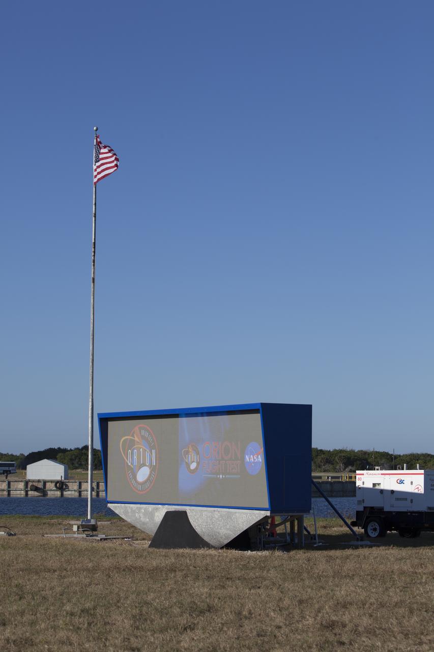 At NASA's Kennedy Space Center in Florida, a shade is placed around the new countdown clock at the spaceport's Press Site. The modern, multimedia display is similar to the screens seen at sporting venues. The new screen is nearly 26 feet wide by 7 feet high, a foot taller than the original clock. The historic countdown clock was designed by Kennedy engineers and built by space center technicians before Apollo 12 in 1969. NASA has acquired the countdown clock from the agency’s Artifact Working Group at the agency's Headquarters for display at the Kennedy Space Center Visitor Complex. 