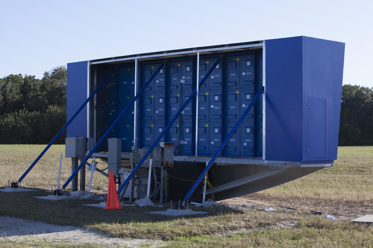 At NASA's Kennedy Space Center in Florida, a shade is placed around the new countdown clock at the spaceport's Press Site. The modern, multimedia display is similar to the screens seen at sporting venues. The new screen is nearly 26 feet wide by 7 feet high, a foot taller than the original clock. The historic countdown clock was designed by Kennedy engineers and built by space center technicians before Apollo 12 in 1969. NASA has acquired the countdown clock from the agency’s Artifact Working Group at the agency's Headquarters for display at the Kennedy Space Center Visitor Complex.