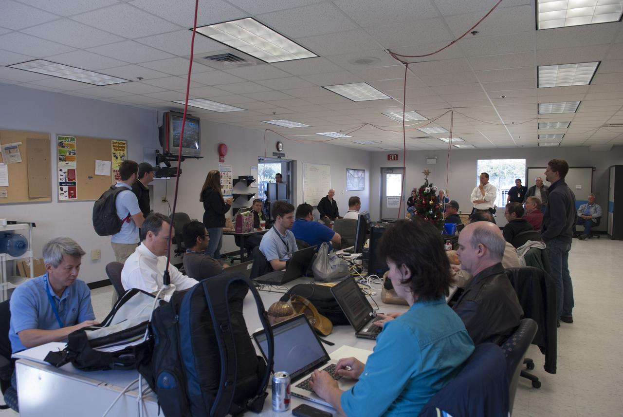 Engineers and controllers in a mobile control room prepare for flight number 15 of NASA's Project Morpheus prototype lander at the north end of the Shuttle Landing Facility, or SLF, at NASA’s Kennedy Space Center in Florida. The lander will take off from the ground over a flame trench and use its autonomous landing and hazard avoidance technology, or ALHAT sensors, to survey the hazard field to determine safe landing sites. Project Morpheus tests NASA’s ALHAT and an engine that runs on liquid oxygen and methane, which are green propellants. These new capabilities could be used in future efforts to deliver cargo to planetary surfaces. Project Morpheus is being managed under the Advanced Exploration Systems, or AES, Division in NASA’s Human Exploration and Operations Mission Directorate.