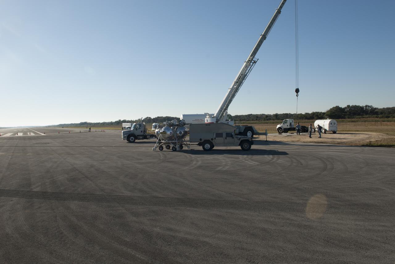 NASA’s Project Morpheus prototype lander is moved into position at the north end of the Shuttle Landing Facility at Kennedy Space Center in Florida in preparation for free flight test No. 15. During the 97-second test, onboard autonomous landing and hazard avoidance technology sensors, or ALHAT, surveyed the hazard field for safe landing sites, then guided the lander forward and downward to a successful landing.