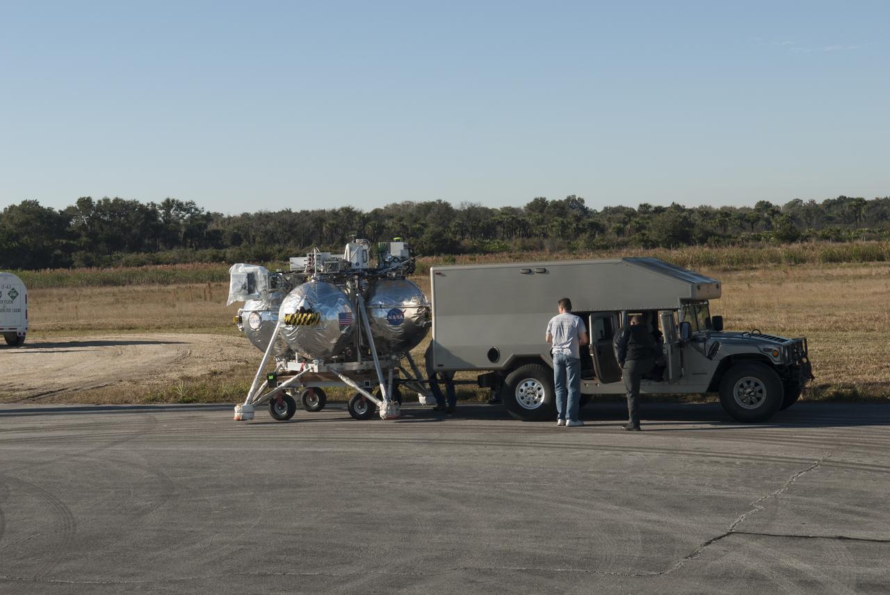 NASA’s Project Morpheus prototype lander is moved into position at the north end of the Shuttle Landing Facility at Kennedy Space Center in Florida in preparation for free flight test No. 15. During the 97-second test, onboard autonomous landing and hazard avoidance technology sensors, or ALHAT, surveyed the hazard field for safe landing sites, then guided the lander forward and downward to a successful landing.