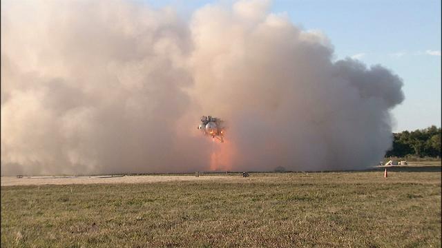 NASA’s Project Morpheus prototype lander is enveloped in a cloud of dust as it takes off on free flight test No. 15 at the north end of the Shuttle Landing Facility at Kennedy Space Center in Florida. During the 97-second test, onboard autonomous landing and hazard avoidance technology sensors, or ALHAT, surveyed the hazard field for safe landing sites, then guided the lander forward and downward to a successful landing.