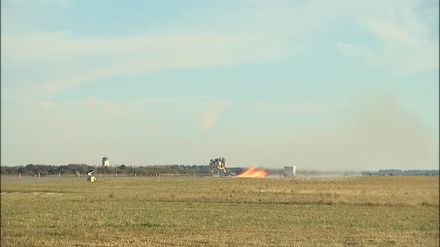 NASA’s Project Morpheus prototype lander takes off on free flight test No. 15 at the north end of the Shuttle Landing Facility at Kennedy Space Center in Florida. During the 97-second test, onboard autonomous landing and hazard avoidance technology sensors, or ALHAT, surveyed the hazard field for safe landing sites, then guided the lander forward and downward to a successful landing.