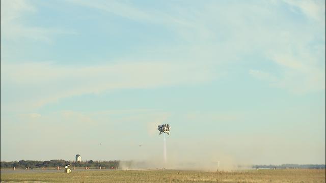 NASA’s Project Morpheus prototype lander soars 800 feet above the north end of the Shuttle Landing Facility at Kennedy Space Center in Florida on free flight test No. 15 at. During the 97-second test, onboard autonomous landing and hazard avoidance technology sensors, or ALHAT, surveyed the hazard field for safe landing sites, then guided the lander forward and downward to a successful landing. 