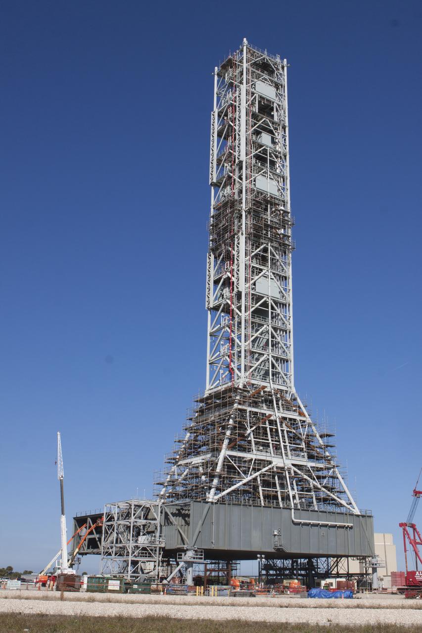 Modifications continue on the Mobile Launcher, or ML, at the Mobile Launcher Park Site at NASA’s Kennedy Space Center in Florida. Scaffolding, or work platforms, have been installed around the base of the tower on the ML to continue upgrades and modifications to the structure. The ML is being modified and strengthened to accommodate the weight, size and thrust at launch of NASA's Space Launch System, or SLS, and Orion spacecraft. The ML is one of the key elements of ground support equipment that is being upgraded by the Ground Systems Development and Operations Program at Kennedy. The ML will carry the SLS rocket and Orion spacecraft to Launch Pad 39B for its first uncrewed mission, Exploration Mission-1, in 2018. 