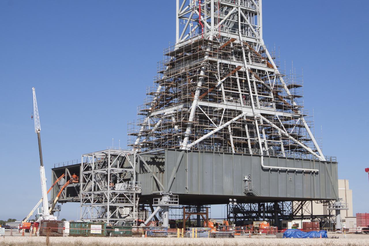 Modifications continue on the Mobile Launcher, or ML, at the Mobile Launcher Park Site at NASA’s Kennedy Space Center in Florida. Scaffolding, or work platforms, have been installed around the base of the tower on the ML to continue upgrades and modifications to the structure. The ML is being modified and strengthened to accommodate the weight, size and thrust at launch of NASA's Space Launch System, or SLS, and Orion spacecraft. The ML is one of the key elements of ground support equipment that is being upgraded by the Ground Systems Development and Operations Program at Kennedy. The ML will carry the SLS rocket and Orion spacecraft to Launch Pad 39B for its first uncrewed mission, Exploration Mission-1, in 2018. 