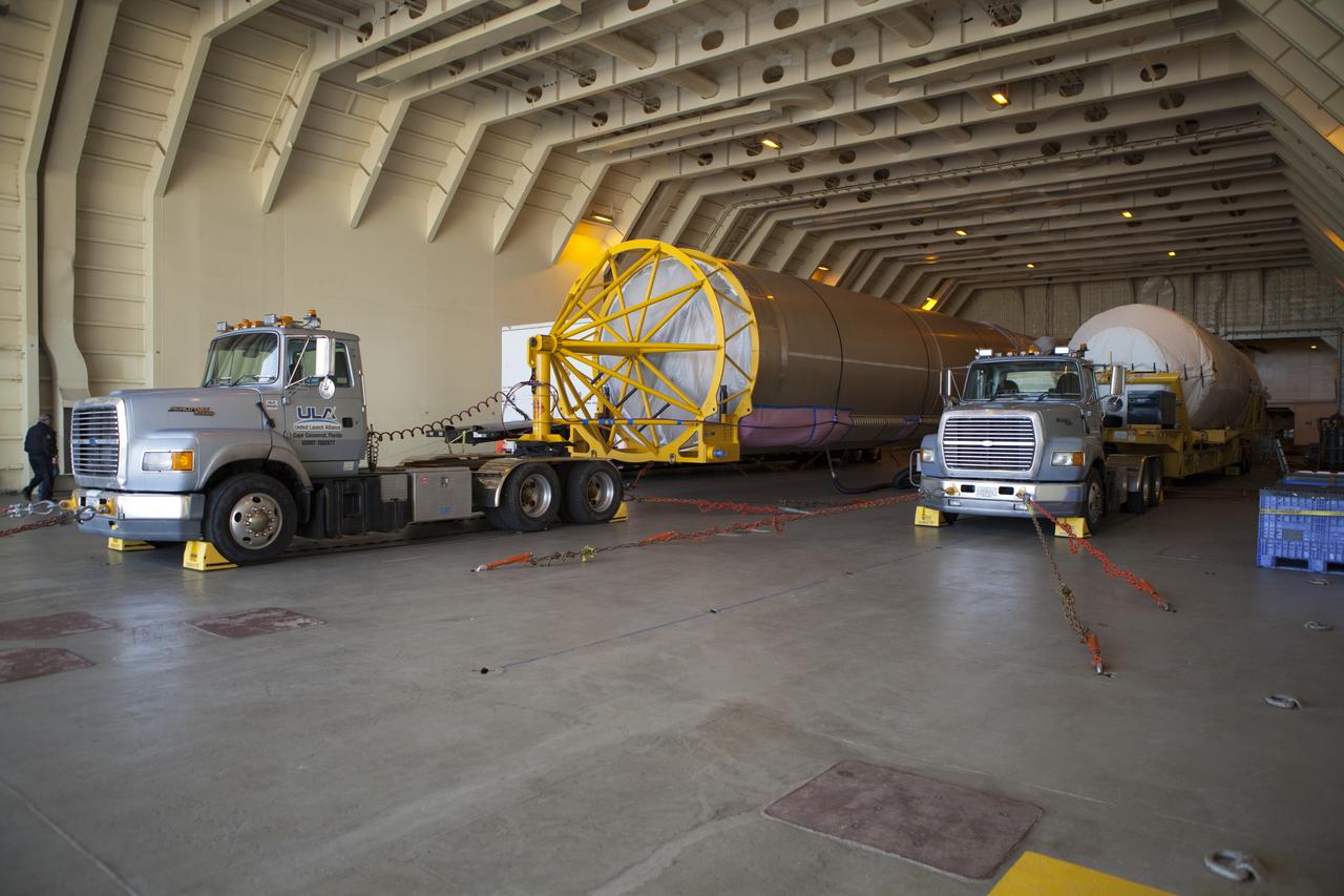 Trucks inside the United Launch Alliance Delta Mariner prepare to transport the Atlas V rocket and Centaur upper stage that will be used to launch NASA's Magnetospheric Multiscale mission.