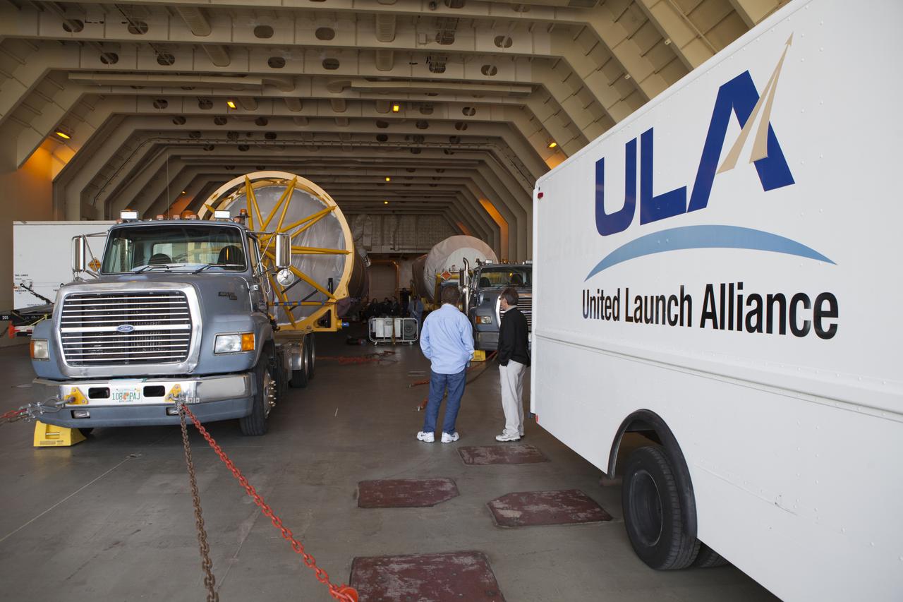 Trucks inside the United Launch Alliance Delta Mariner prepare to transport the Atlas V rocket and Centaur upper stage that will be used to launch NASA's Magnetospheric Multiscale mission. 