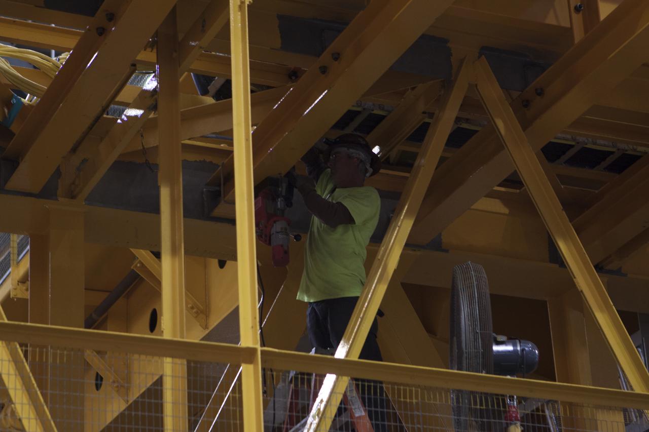 Inside the Vehicle Assembly Building at NASA's Kennedy Space Center in Florida, a construction worker continues with refurbishment and upgrades to the 175-ton crane on the ground floor of the transfer aisle. The crane's 45-year-old controls are being upgraded to improve reliability, precision and safety. The Ground Systems Development and Operations Program is overseeing upgrades and modifications to the crane so that it can support lifting needs for NASA and other exploration vehicles, including the agency's Space Launch System and Orion spacecraft.
