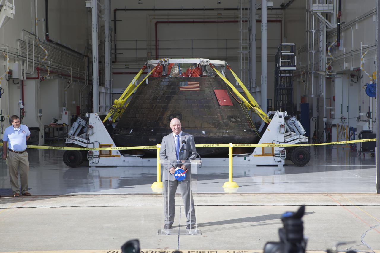 NASA's Orion spacecraft is viewed by members of the media at the Launch Abort System Facility at NASA's Kennedy Space Center in Florida. Kennedy News Chief Mike Curie speaks to the media during the viewing opportunity. Orion made the 8-day, 2,700 mile overland trip back to Kennedy from Naval Base San Diego in California. Analysis of data obtained during its two-orbit, four-and-a-half hour mission Dec. 5 will provide engineers detailed information on how the spacecraft fared. The Ground Systems Development and Operations Program led the recovery, offload and transportation efforts.