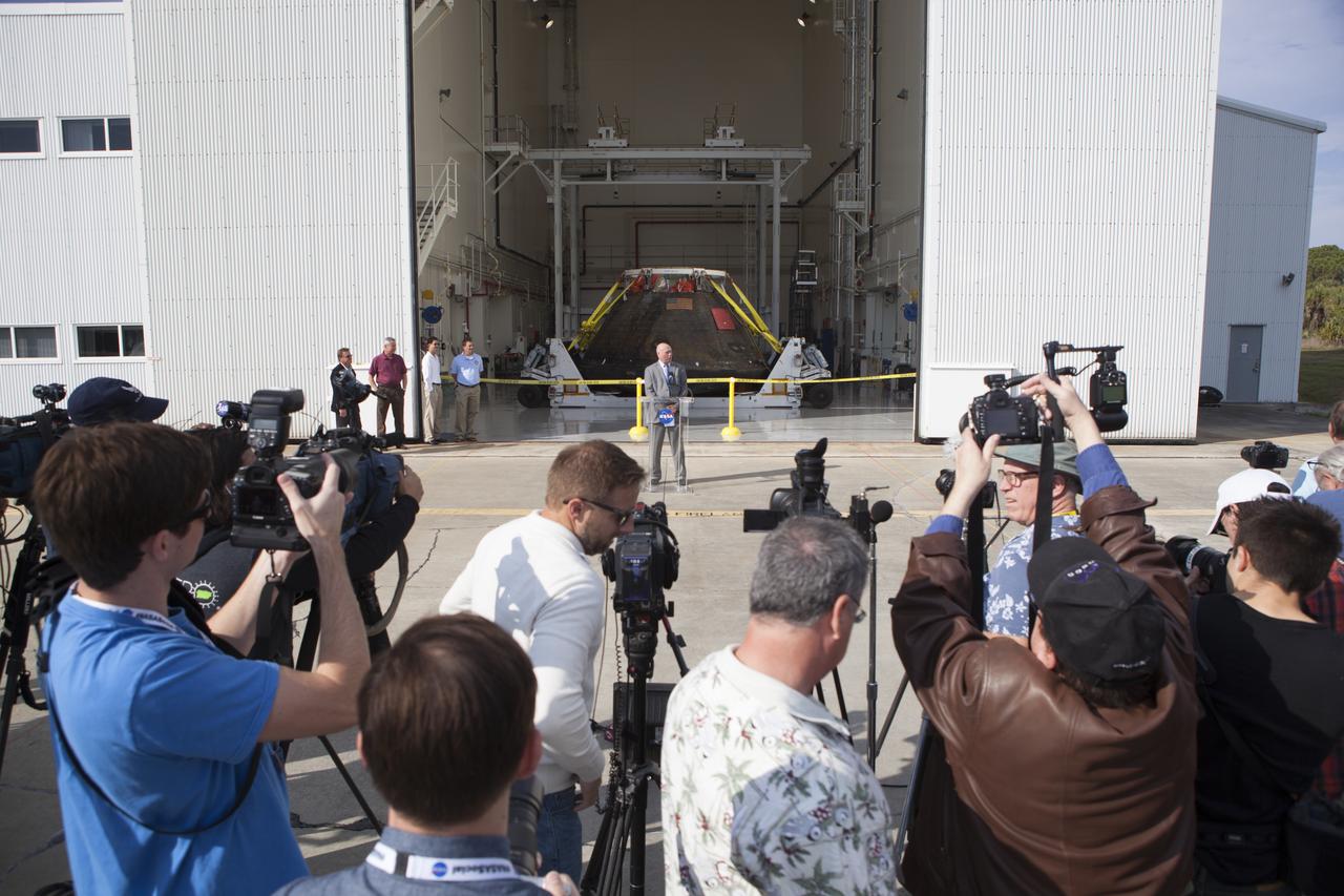 NASA's Orion spacecraft is viewed by members of the media at the Launch Abort System Facility at NASA's Kennedy Space Center in Florida. Kennedy's News Chief Mike Curie speaks to the media during the viewing opportunity. The spacecraft's cross-country return, a 2,700 mile road trip from Naval Base San Diego to Kennedy, sets the stage for in-depth analysis of data obtained during Orion's trip to space. It will provide engineers with detailed information on how the spacecraft fared during its two-orbit, 4.5-hour flight test, completed on Dec. 5. The Ground Systems Development and Operations Program led the recovery, offload and transportation efforts.