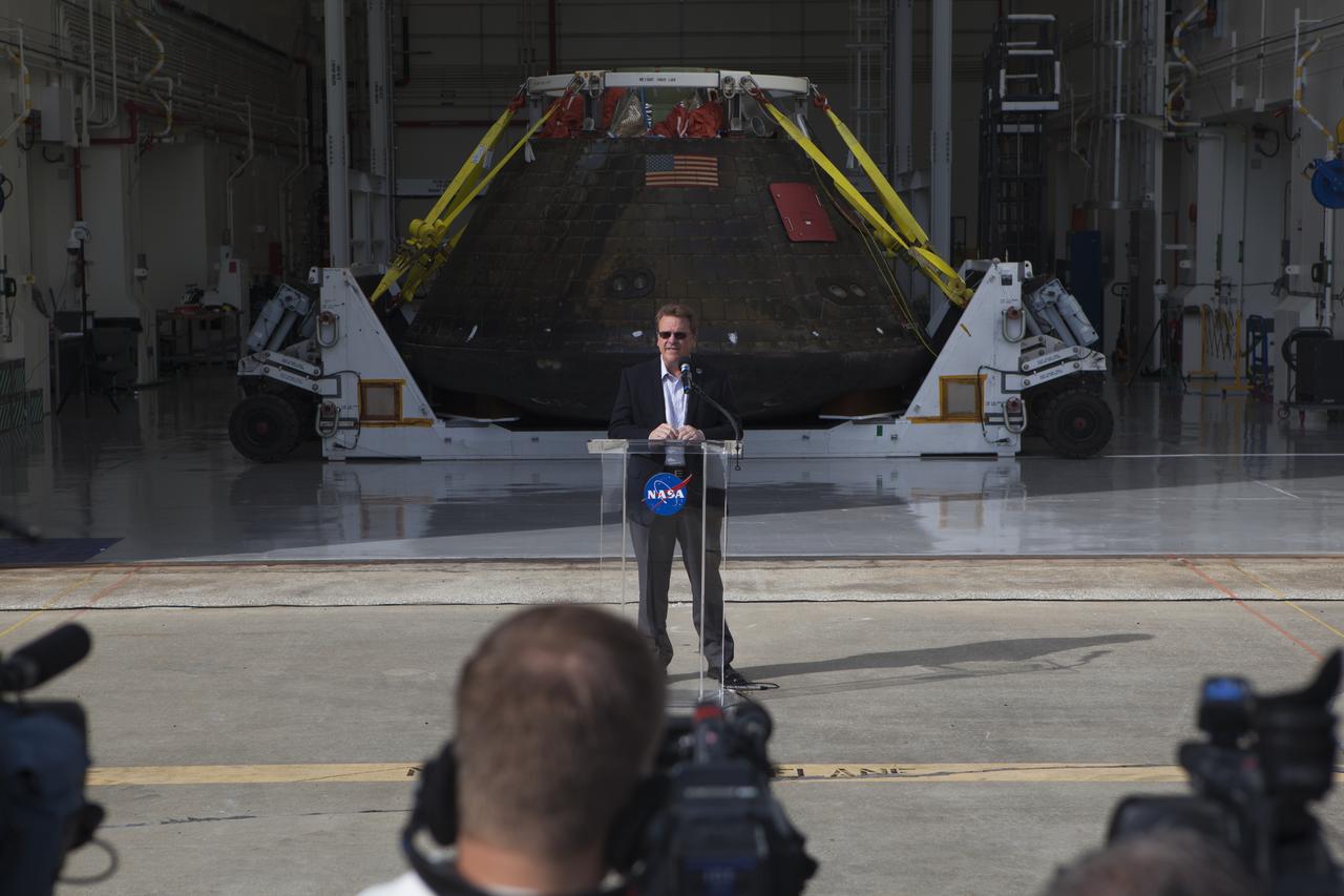 Lockheed Martin Manager Jules Schneider speaks to members of the media during a viewing of NASA's Orion spacecraft at the Launch Abort System Facility at NASA's Kennedy Space Center in Florida. The spacecraft's cross-country return, a 2,700 mile road trip from Naval Base San Diego to Kennedy, sets the stage for in-depth analysis of data obtained during Orion's trip to space. It will provide engineers detailed information on how the spacecraft fared during its two-orbit, 4.5-hour flight test, completed on Dec. 5. The Ground Systems Development and Operations Program led the recovery, offload and transportation efforts.