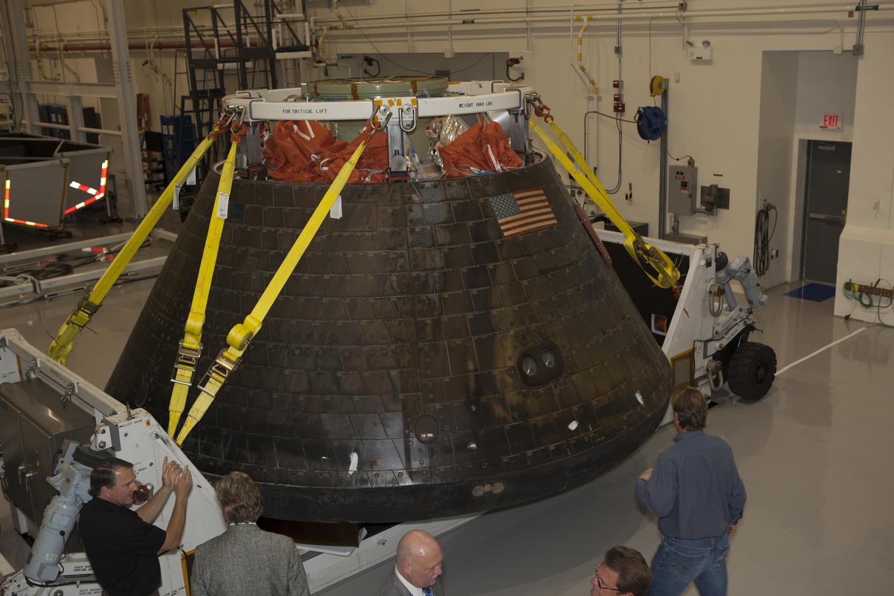 NASA's Orion spacecraft is viewed by members of the media at the Launch Abort System Facility at NASA's Kennedy Space Center in Florida. Orion made the 8-day, 2,700 mile overland trip back to Kennedy from Naval Base San Diego in California. Analysis of date obtained during its two-orbit, four-and-a-half hour mission Dec. 5 will provide engineers detailed information on how the spacecraft fared. The Ground Systems Development and Operations Program led the recovery, offload and transportation efforts.