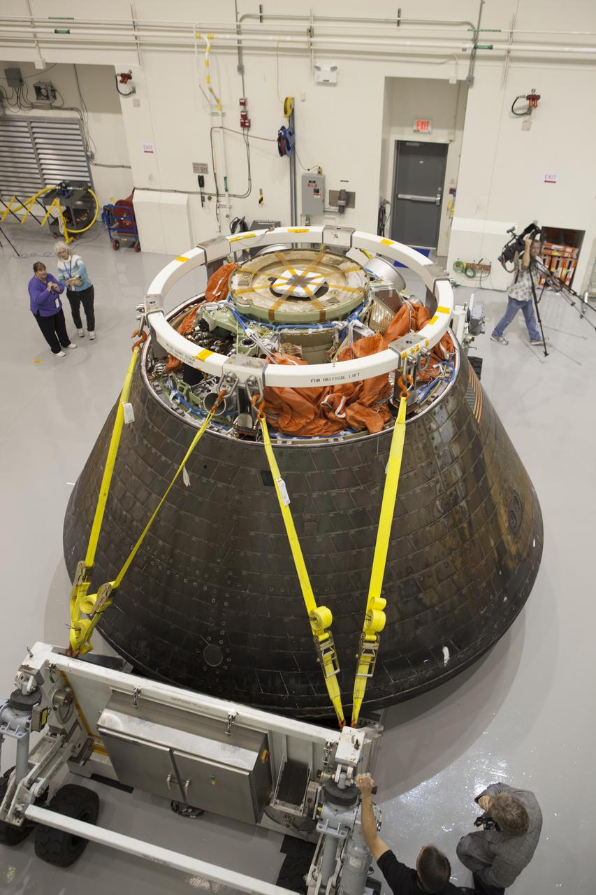 NASA's Orion spacecraft is viewed by members of the media at the Launch Abort System Facility at NASA's Kennedy Space Center in Florida. Orion made the 8-day, 2,700 mile overland trip back to Kennedy from Naval Base San Diego in California. Analysis of date obtained during its two-orbit, four-and-a-half hour mission Dec. 5 will provide engineers with detailed information on how the spacecraft fared. The Ground Systems Development and Operations Program led the recovery, offload and transportation efforts.