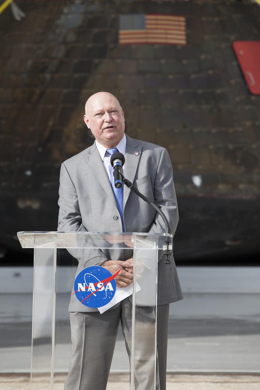 NASA's Orion spacecraft is viewed by members of the media at the Launch Abort System Facility at NASA's Kennedy Space Center in Florida. Kennedy News Chief Mike Curie speaks to the media during the viewing opportunity. Orion made the 8-day, 2,700 mile overland trip back to Kennedy from Naval Base San Diego in California. Analysis of date obtained during its two-orbit, four-and-a-half hour mission Dec. 5 will provide engineers with detailed information on how the spacecraft fared. The Ground Systems Development and Operations Program led the recovery, offload and transportation efforts.