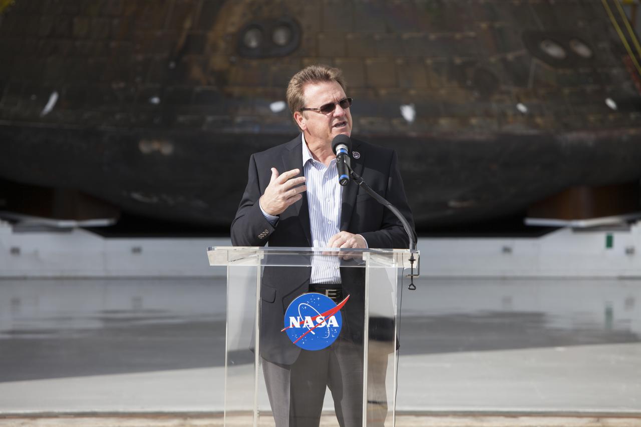 Lockheed Martin Manager Jules Schneider speaks to members of the media during a viewing of NASA's Orion spacecraft at the Launch Abort System Facility at NASA's Kennedy Space Center in Florida. The spacecraft's cross-country return, a 2,700 mile road trip from Naval Base San Diego to Kennedy, sets the stage for in-depth analysis of data obtained during Orion's trip to space. It will provide engineers with detailed information on how the spacecraft fared during its two-orbit, 4.5-hour flight test, completed on Dec. 5. The Ground Systems Development and Operations Program led the recovery, offload and transportation efforts. 