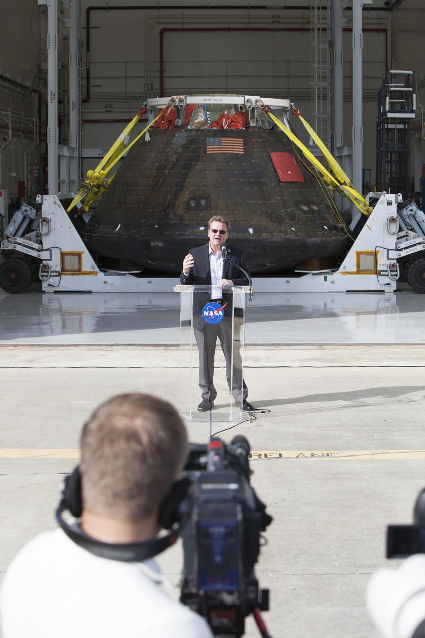Lockheed Martin Manager Jules Schneider speaks to members of the media during a viewing of NASA's Orion spacecraft at the Launch Abort System Facility at NASA's Kennedy Space Center in Florida. The spacecraft's cross-country return, a 2,700 mile road trip from Naval Base San Diego to Kennedy, sets the stage for in-depth analysis of data obtained during Orion's trip to space. It will provide engineers with detailed information on how the spacecraft fared during its two-orbit, 4.5-hour flight test, completed on Dec. 5. The Ground Systems Development and Operations Program led the recovery, offload and transportation efforts. 