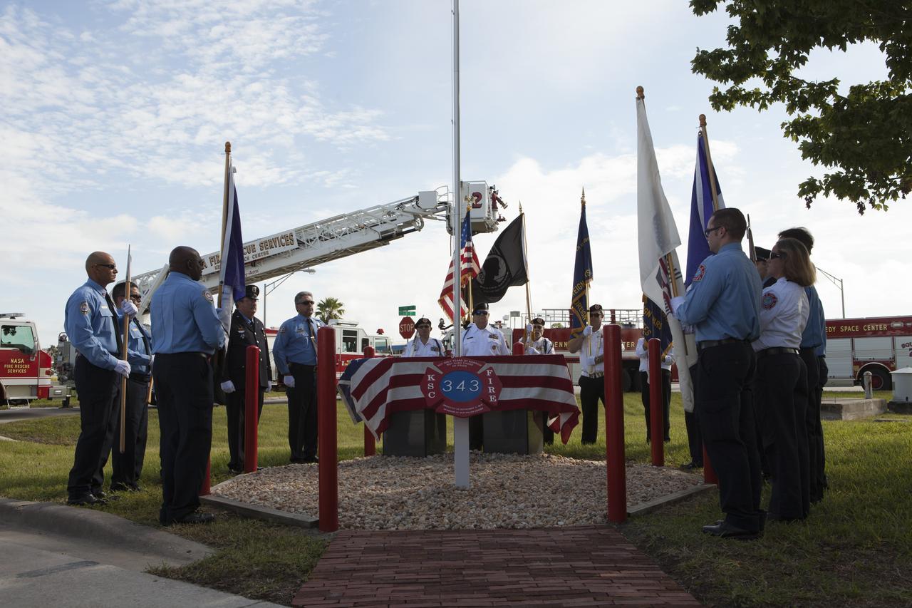 The honor guard for the Fire Department at NASA's Kennedy Space Center conducts the dedication service for a memorial to the 343 first responder victims of the Sept. 11, 2001, terror attacks at Fire Station 1 at Kennedy on Sept. 11, 2015. The ceremony dedicated a monument that includes a section of steel I-beam from the World Trade Center in New York. 