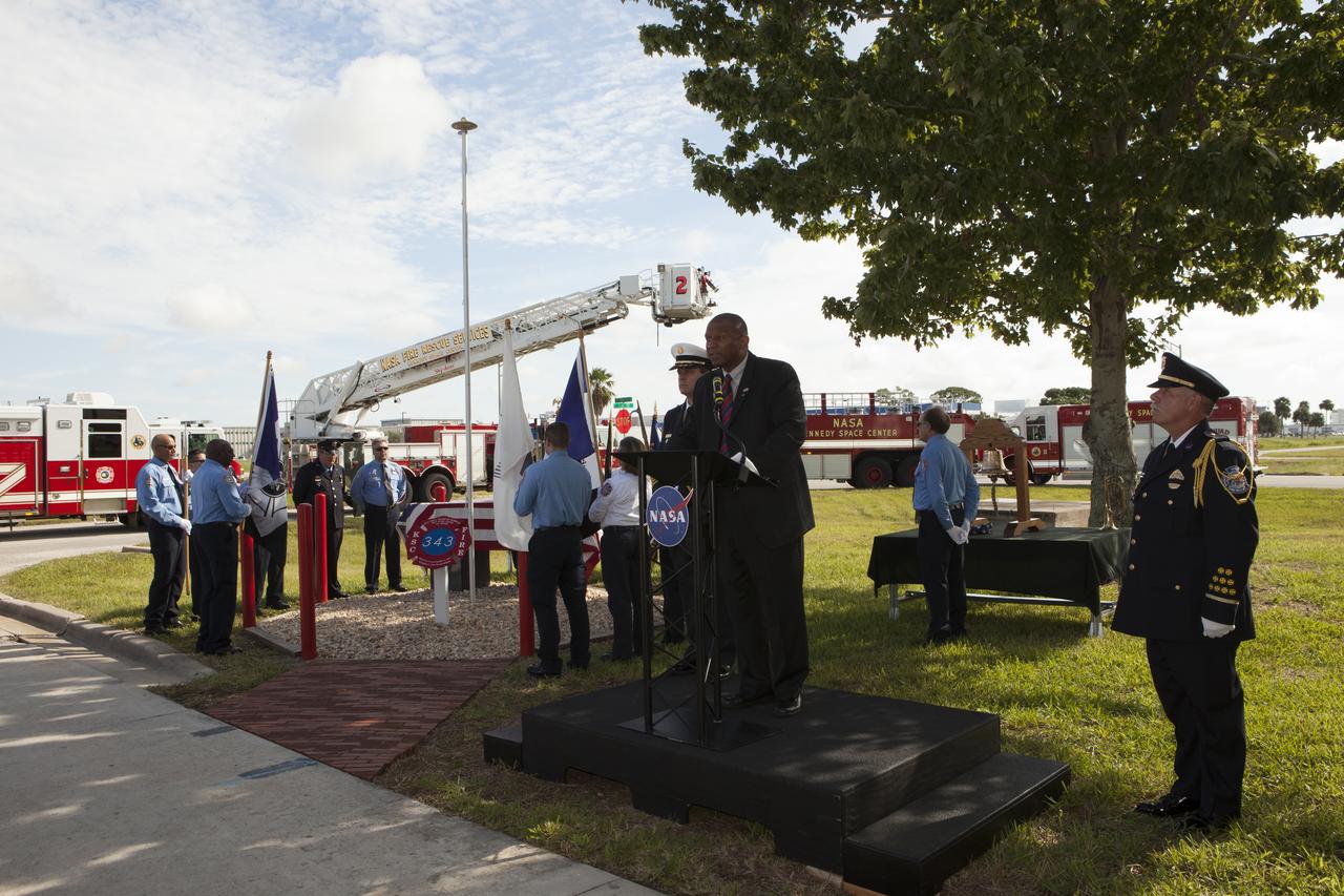 Kelvin Manning, associate director of NASA's Kennedy Space Center, speaks during the dedication service for a memorial to the 343 first responder victims of the Sept. 11, 2001, terror attacks at Fire Station 1 at Kennedy on Sept. 11, 2015. The ceremony dedicated a monument that includes a section of steel I-beam from the World Trade Center in New York. 