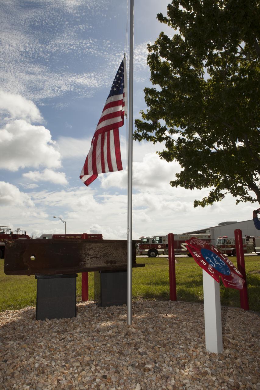 A memorial to the 343 first responder victims of the Sept. 11, 2001, terror attacks stands at Fire Station 1 at NASA's Kennedy Space Center during its dedication on Sept. 11, 2015. A section of steel I-beam from the World Trade Center in New York forms the centerpiece of the monument.