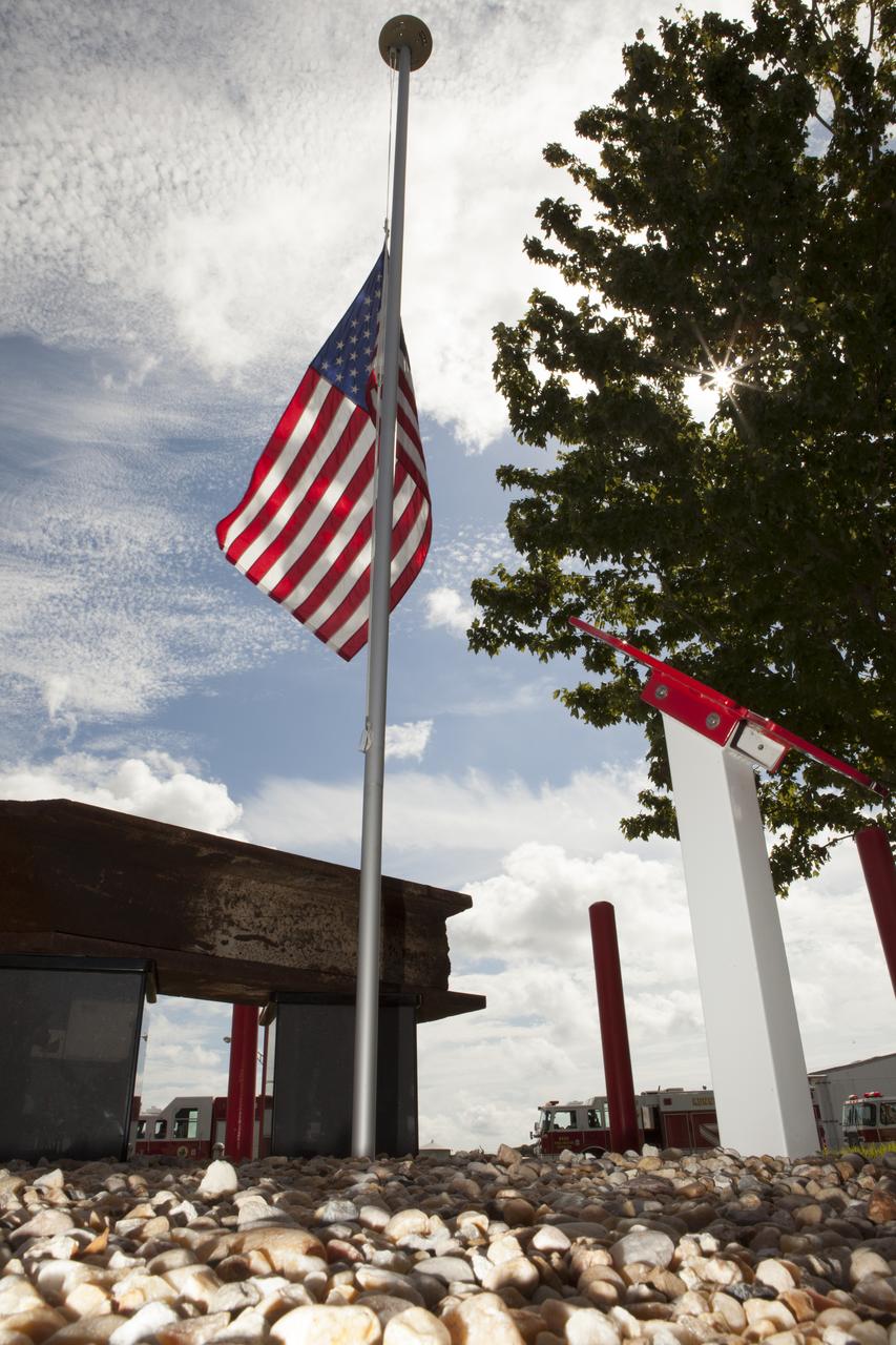 A memorial to the 343 first responder victims of the Sept. 11, 2001, terror attacks stands at Fire Station 1 at NASA's Kennedy Space Center during its dedication on Sept. 11, 2015. A section of steel I-beam from the World Trade Center in New York forms the centerpiece of the monument.