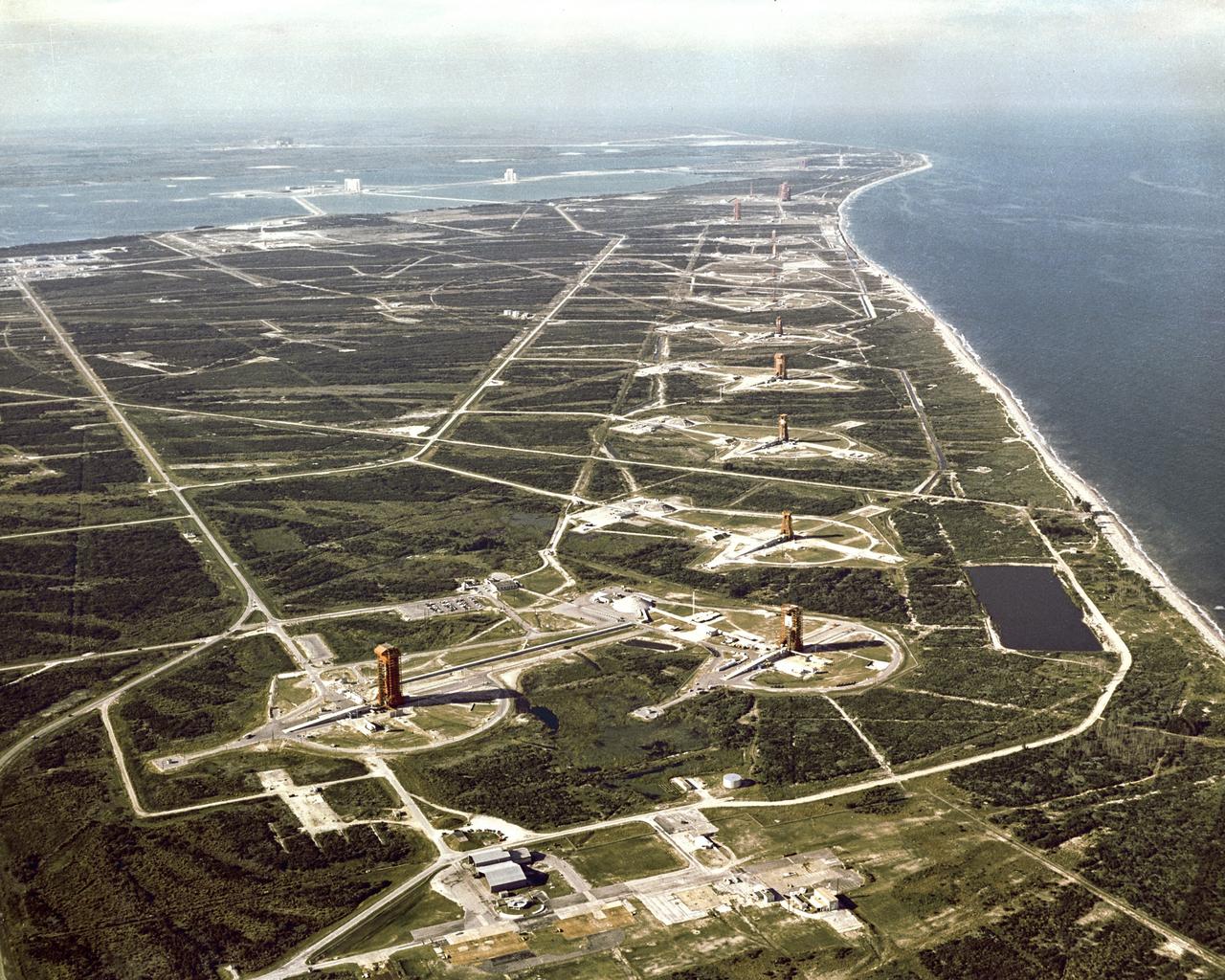 CAPE CANAVERAL, Fla. -- Overall aerial view of "Missile Row," Cape Kennedy Air Force Station. The view is looking north, with the Vehicle Assembly Building under construction in the upper left-hand corner. Photo credit: NASA