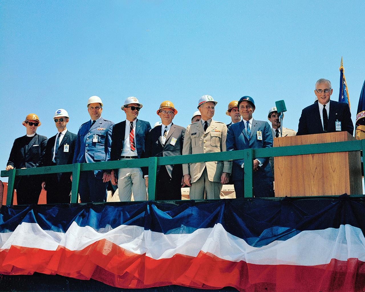 Dignataries (KSC Director Dr. Kurt Debus is second from right, NASA Administrator James C. Fletcher speaking), at the Last Major Beam Installation, attending the VAB Topping-Off Ceremony. MILA.