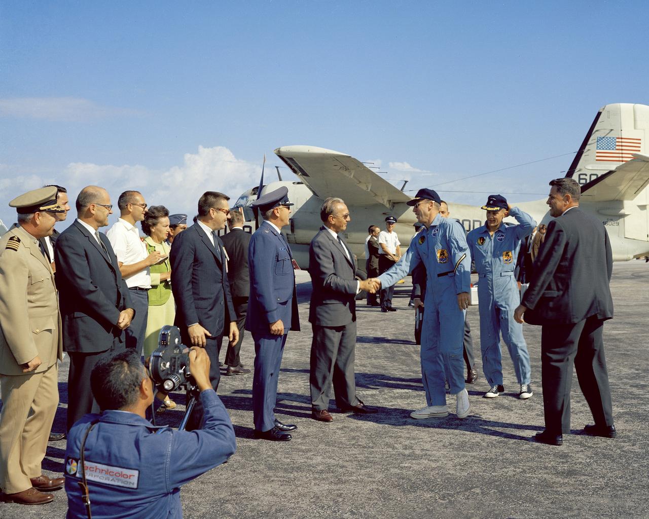 CAPE KENNEDY, Fla. -- At the Cape Kennedy Air Force Station skid strip, Dr. Kurt H. Debus, director of the Kennedy Space Center, greets returning Gemini 12 astronauts James A. Lovell and Edwin E. Buzz Aldrin Jr. following their four-day Earth orbital mission. Photo Credit: NASA