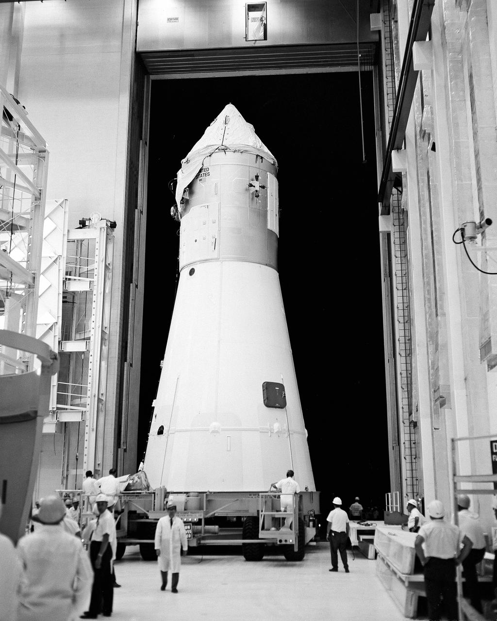 Apollo spacecraft 017 leaves the Manned Spacecraft Operations Building at Kennedy Space Center on its way to the Vehicle Assembly Building where it will be mated with the Saturn 501 launch vehicle.  The first flight of the Saturn V [AS-501], an unmanned mission, is scheduled for this fall.