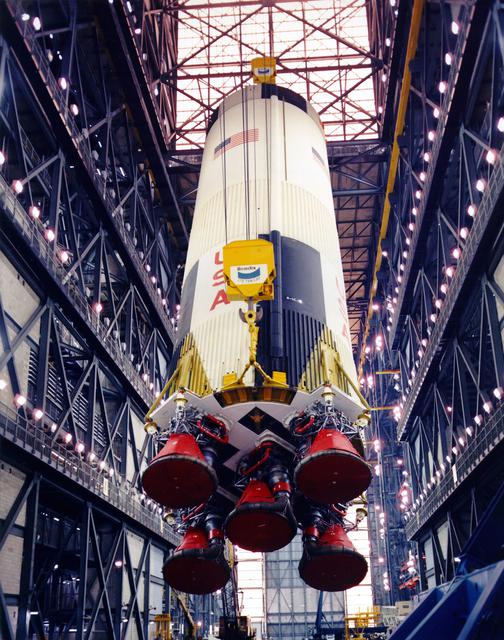 Teams lift the first stage of the Apollo 10 Saturn V rocket by crane inside High Bay 3 of the Vehicle Assembly Building at NASA’s Kennedy Space Center in Florida on Dec. 3, 1968, in preparation for stacking on the mobile launcher. The 138-foot-long stage generated 7.5 million pounds of thrust when it launched Apollo 10 astronauts Thomas P. Stafford, John W. Young, and Eugene A. Cernan. The mission launched on May 18, 1969, and was the first flight of a complete, crewed Apollo spacecraft to operate around the Moon. 