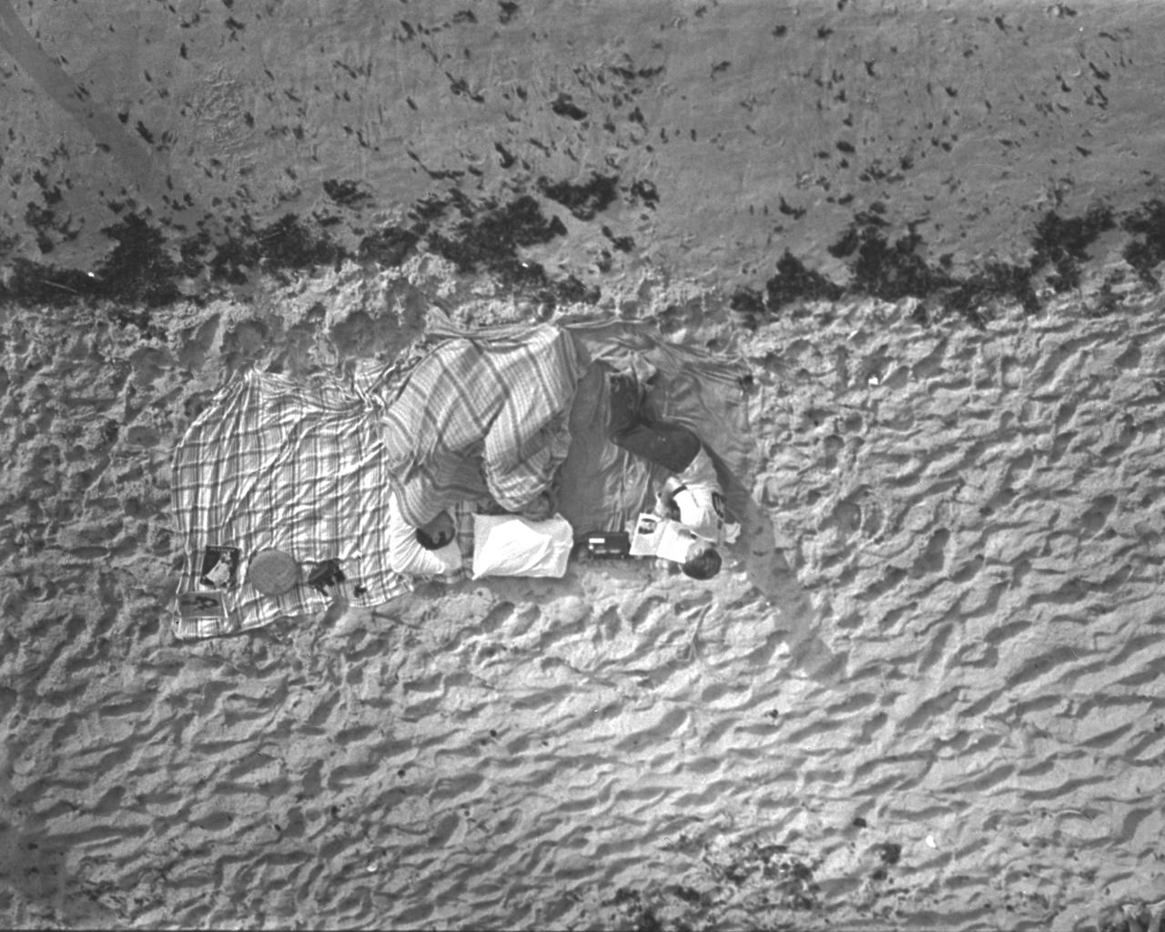 CAPE CANAVERAL, Fla. -- These three were among the thousands of persons who camped on beaches and roads adjacent to the Kennedy Space Center to watch the Apollo 11 launch. An estimated one million persons visited the Spaceport area to see the historic flight, the nation's first attempt to land Americans on the lunar surface.  Photo credit: NASA