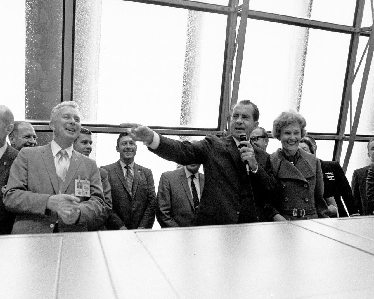 CAPE CANAVERAL, Fla. -- At the Kennedy Space Center in Florida, President Richard M. Nixon speaks in the Launch Control Center after the successful liftoff of the Apollo 12 space vehicle, which sent astronauts Charles Conrad, Jr., Richard F. Gordon and Alan Bean on the first leg of their lunar landing mission. With the President are Paul Donnelly, Launch Operations manager, on the left, and First Lady Pat Nixon, on the right. Photo Credit: NASA