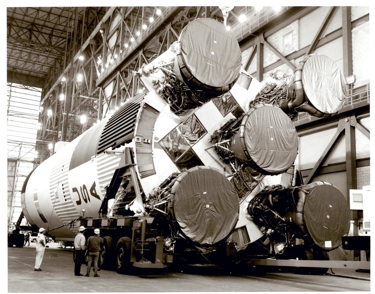 Teams attach the S-1C (first stage) booster for the Apollo 11 Saturn V rocket to cranes in preparation for lifting and stacking on its mobile launcher inside the Vehicle Assembly Building at NASA’s Kennedy Space Center in Florida in February 1969. The booster is 138 feet tall, 33 feet in diameter, and produces 7.5 million pounds of thrust from its five powerful engines. Apollo 11 was the first flight that landed humans on the Moon under the Apollo Program. The mission launched on July 16, 1969, and members of the crew included Commander Neil A. Armstrong, Command Module Pilot Michael Collins, and Lunar Module Pilot Edwin “Buzz” Aldrin.